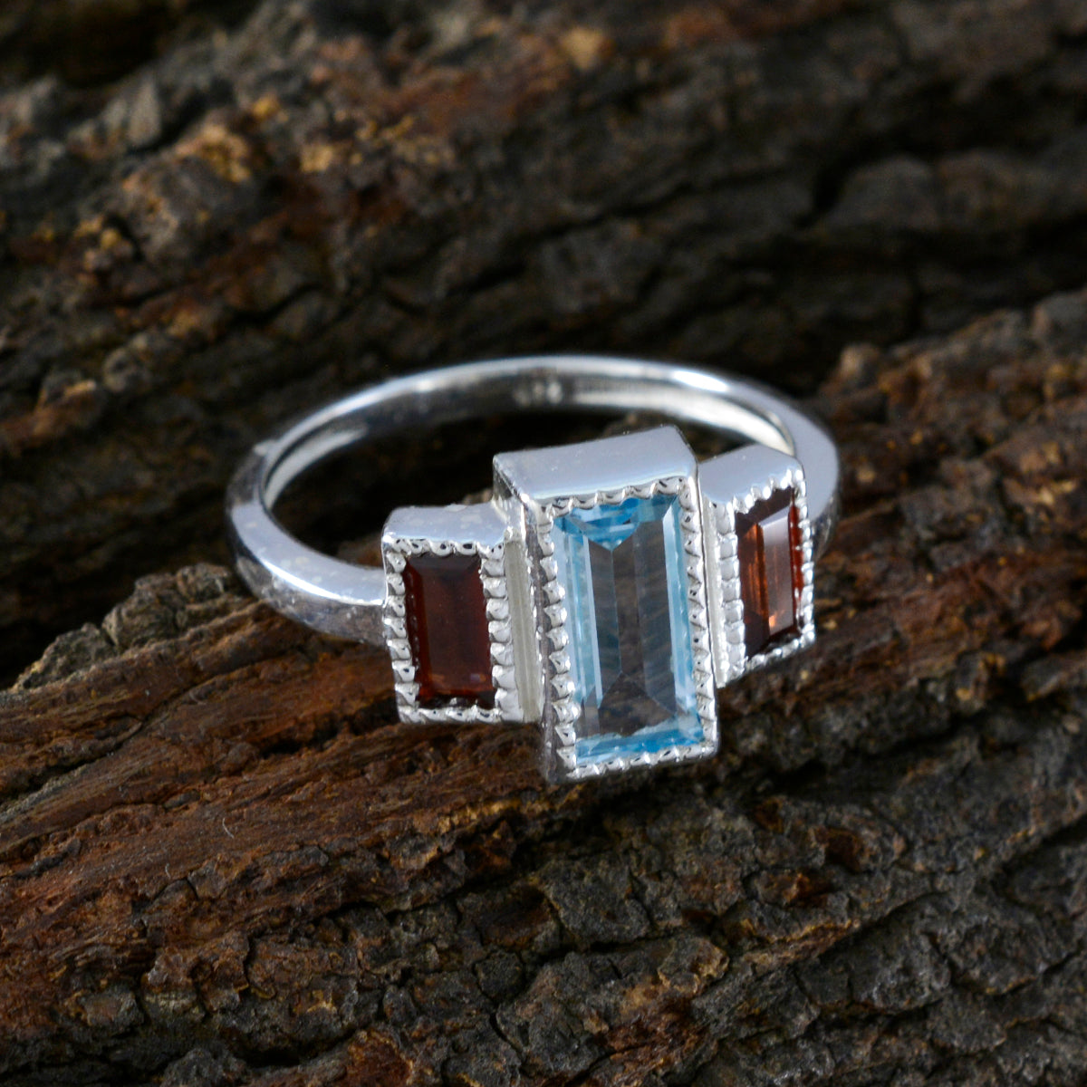 Elena multicolor trilogy ring with rectangular blue center stone and two red side stones on silver band for everyday wear
