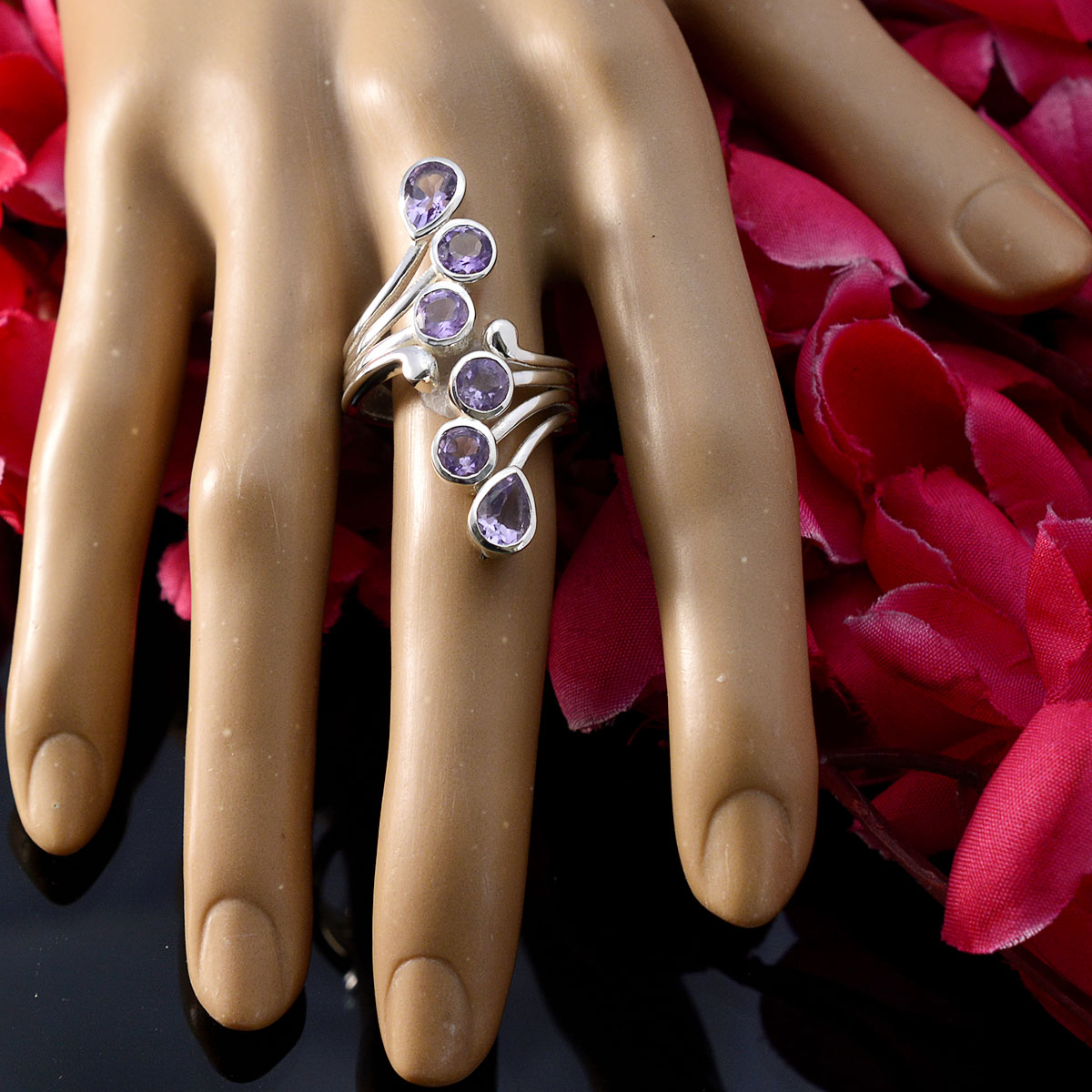 Victoria silver ring with cascading amethyst stones on hand surrounded by petals purple gemstone ring for women swirl design