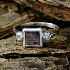 Scarlett purple gemstone trilogy ring with square purple center stone and two round clear side stones on silver band