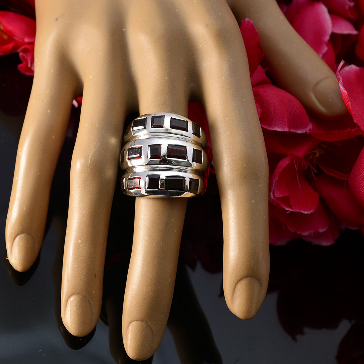 Lily silver ring with red stones modeled as red cocktail ring for women on display hand