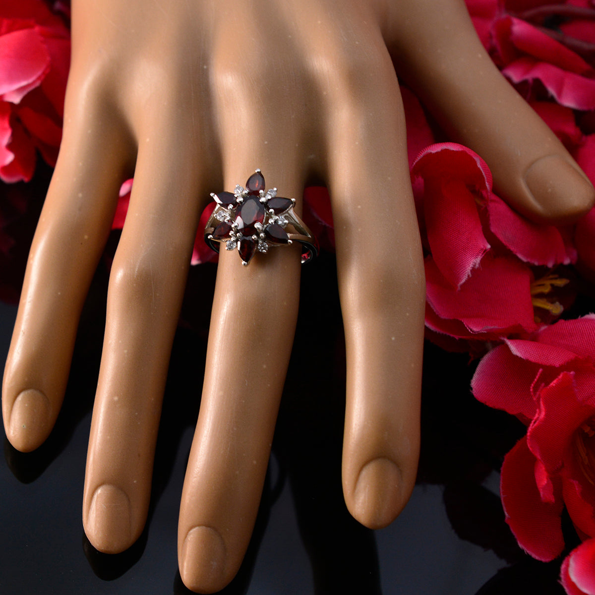 Lorena red floral gemstone ring with marquise ruby like stones in silver floral cluster on model hand