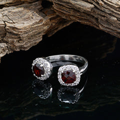 Valentina red gemstone toi et moi ring with two red gemstones and silver band on black reflective surface