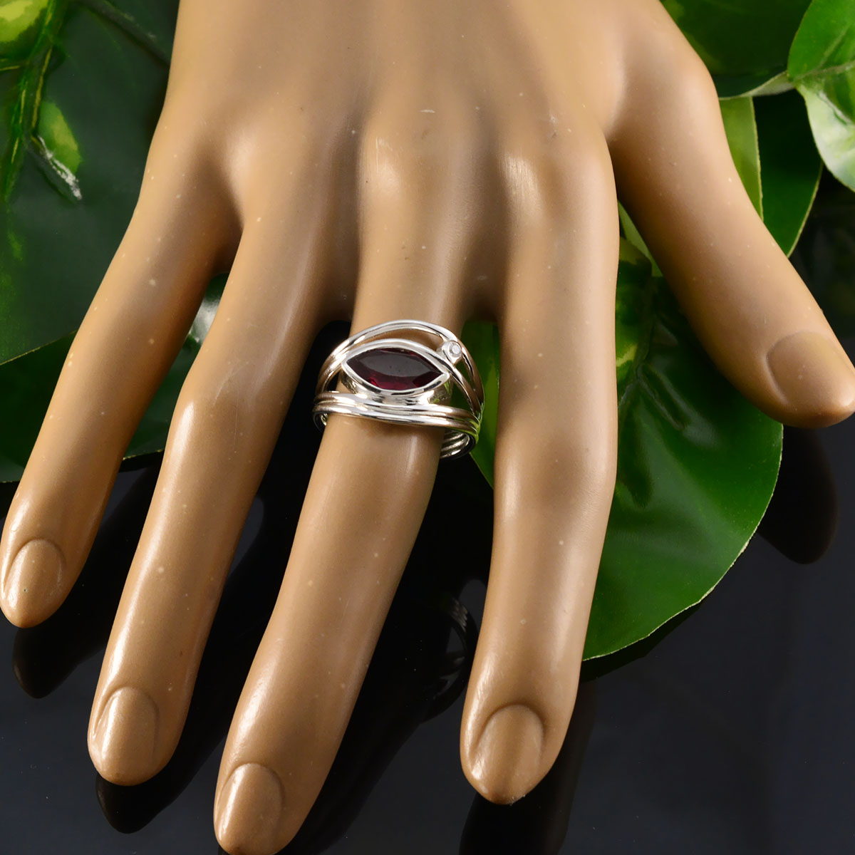 Teresa red gemstone toi et moi ring with silver band displayed on hand mannequin