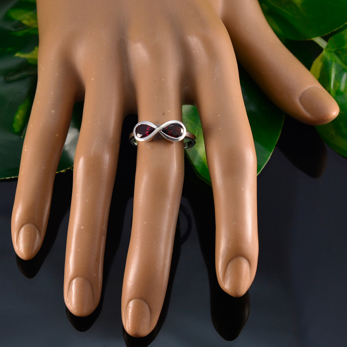 Tereza red gemstone toi et moi ring with silver infinity design on mannequin hand