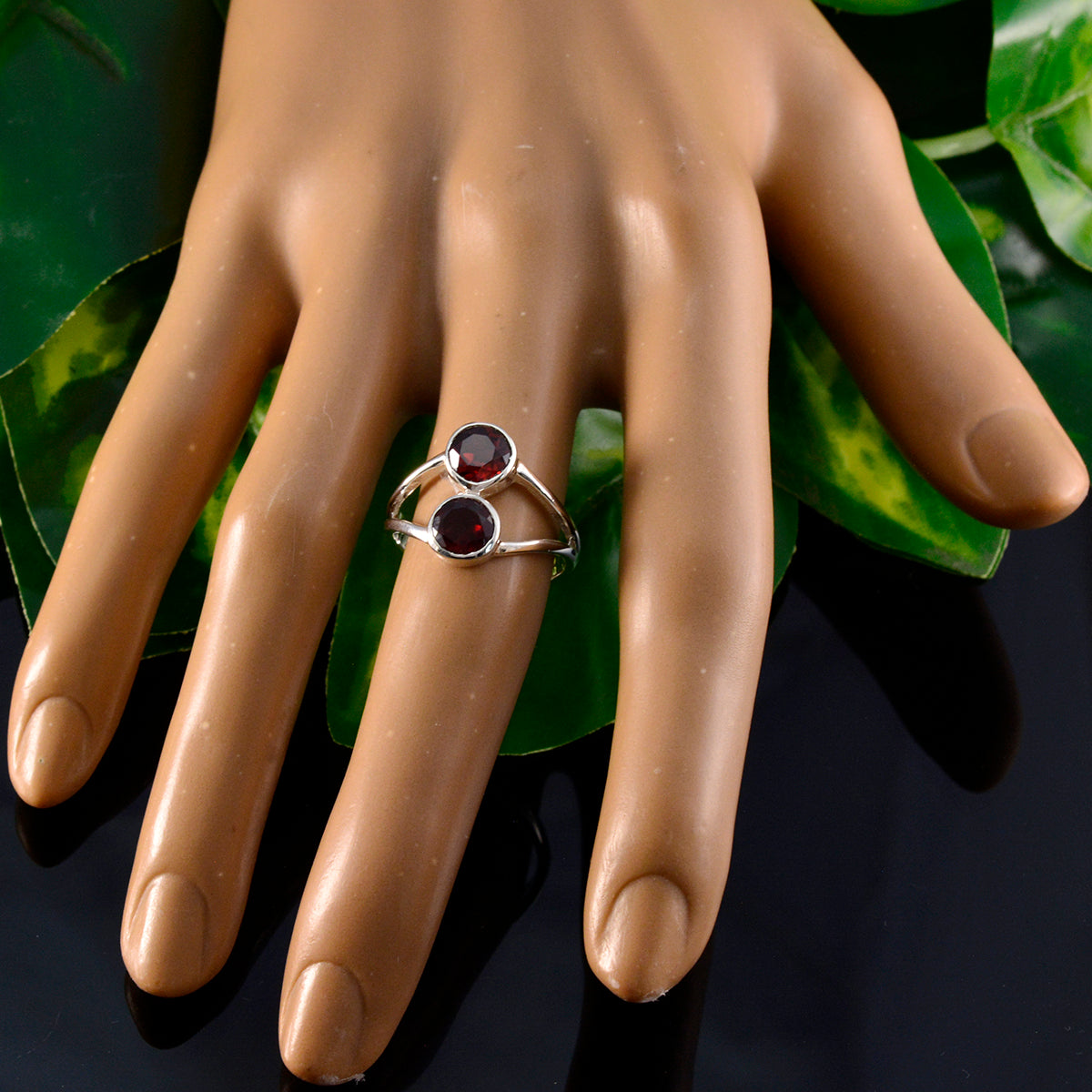 Olivia red toi et moi ring with two red gemstones on silver band worn on hand
