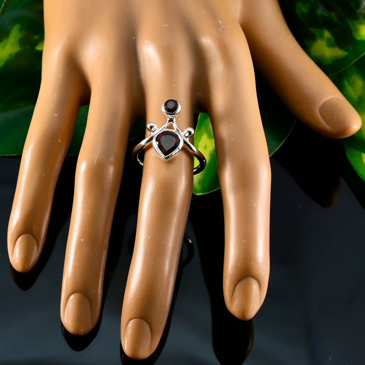 Savannah red toi et moi ring with two red gemstones on silver band displayed on a hand model