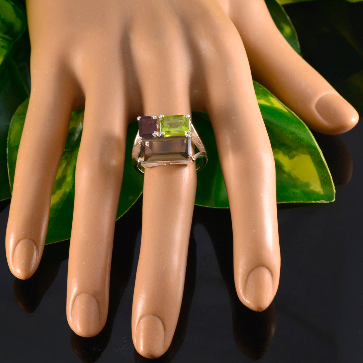 Lucia trendy multicolor trilogy ring with three rectangular gemstones on a display hand