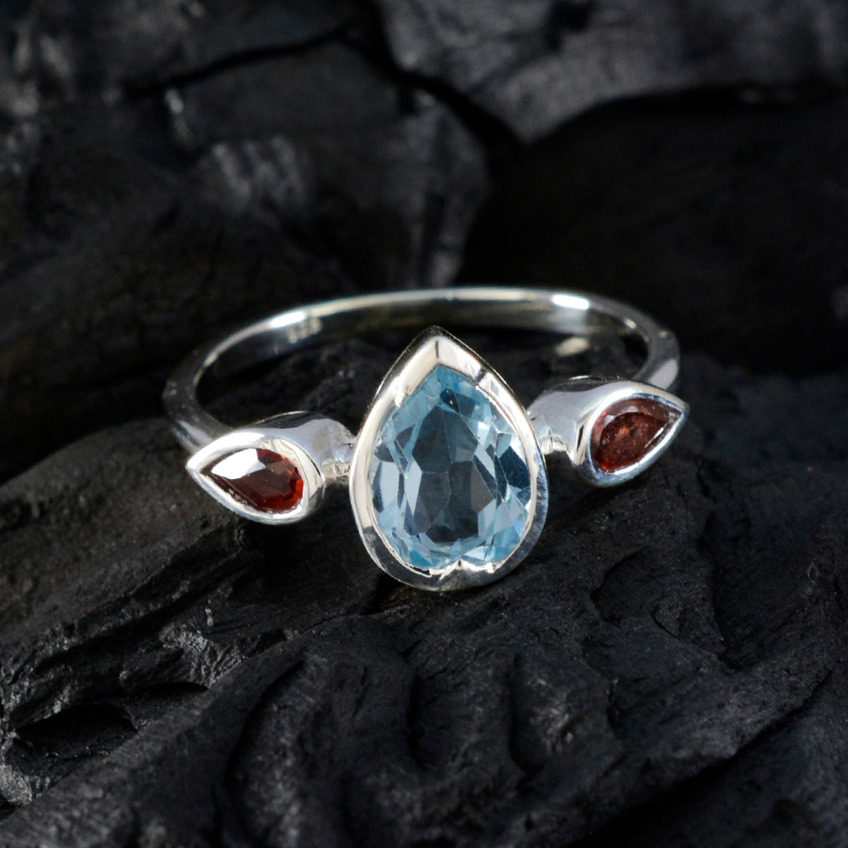 Soojin trendy multicolor trilogy ring with pear blue topaz center and two red garnet side stones in silver band