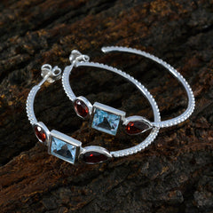 Trilogy gemstone earrings Riyo with blue and red stones set in a delicate silver hoop design