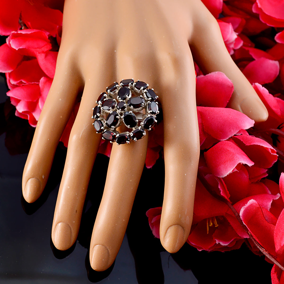 Natalie Victorian red gemstone ring with multiple oval red stones set in silver on display hand