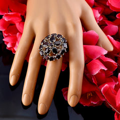 Natalie Victorian red gemstone ring with multiple oval red stones set in silver on display hand