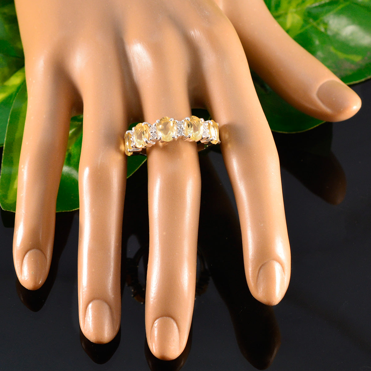 Stella yellow gemstone ring with five oval yellow stones in gold band displayed on mannequin hand