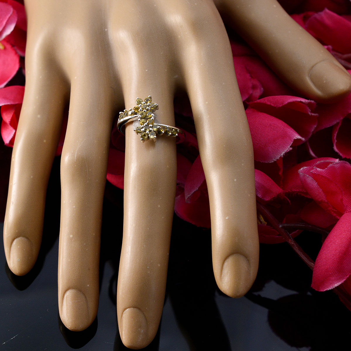 Kristine yellow gemstone ring cluster style on mannequin hand with gold band and pink flowers