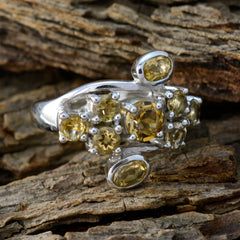 Putri sterling silver ring with clustered yellow gemstones and oval accents on wood yellow navratna ring