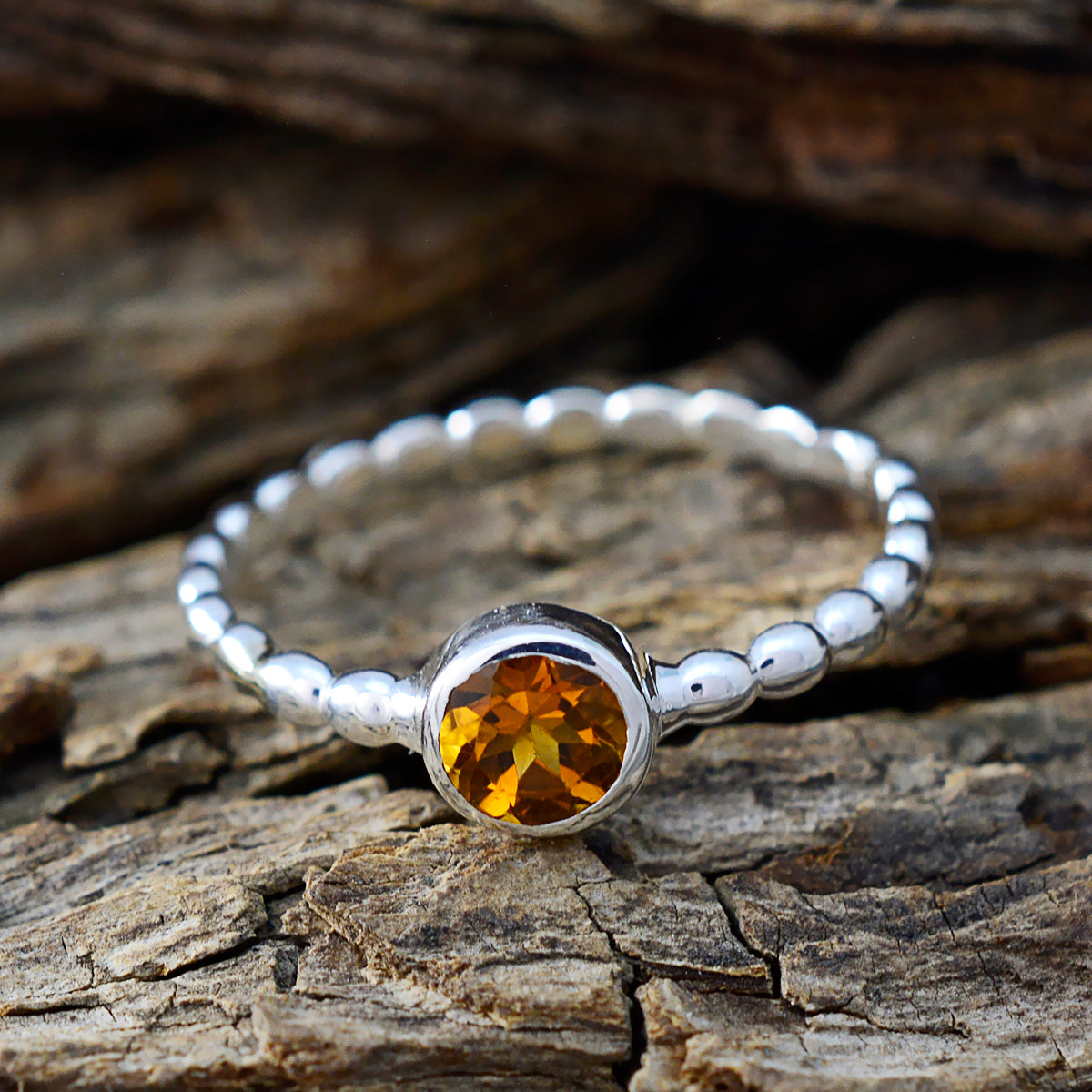 Saanvi silver beaded band ring with bezel set yellow citrine on wood background yellow solitaire ring for women