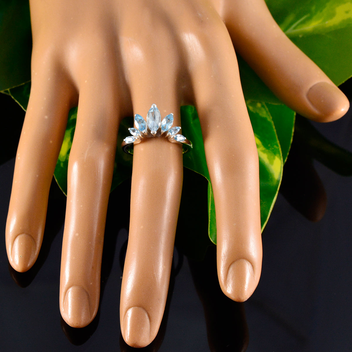 Eleanor blue gemstone crown ring with marquise-cut stones on a silver band displayed on a mannequin hand