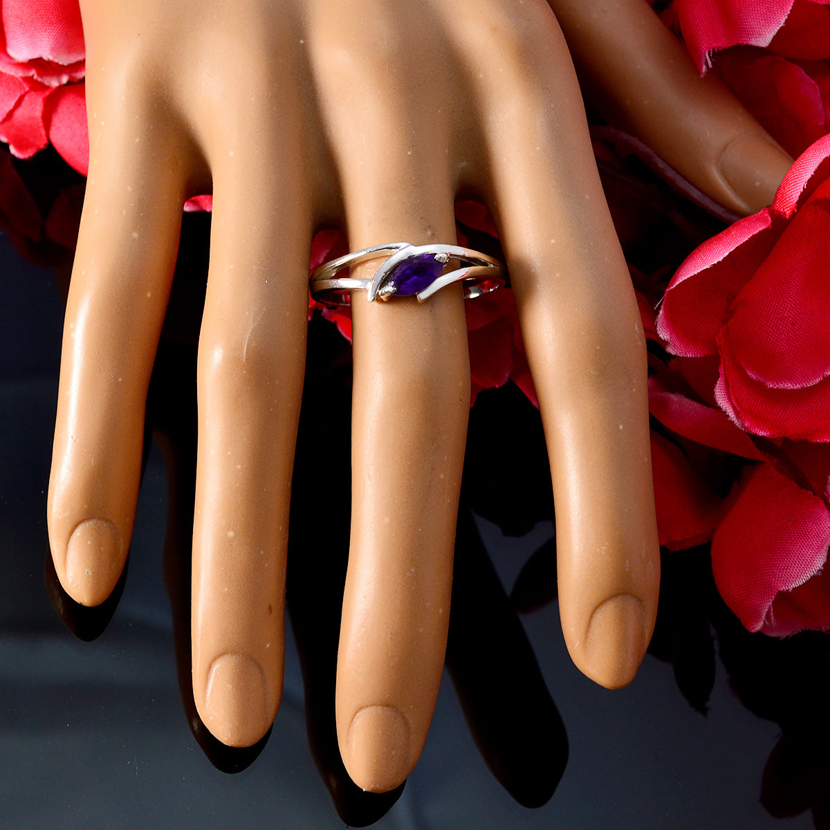 Hua purple solitaire ring for women with marquise cut stone on silver band displayed on mannequin hand