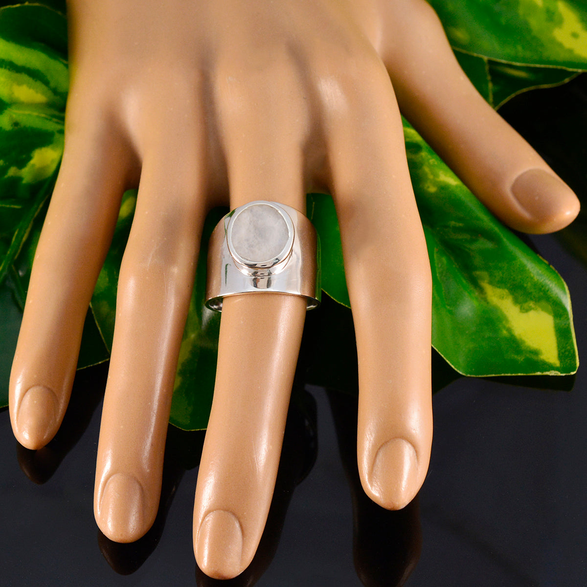 Gabriela white solitaire ring for women with a wide silver band and round white stone