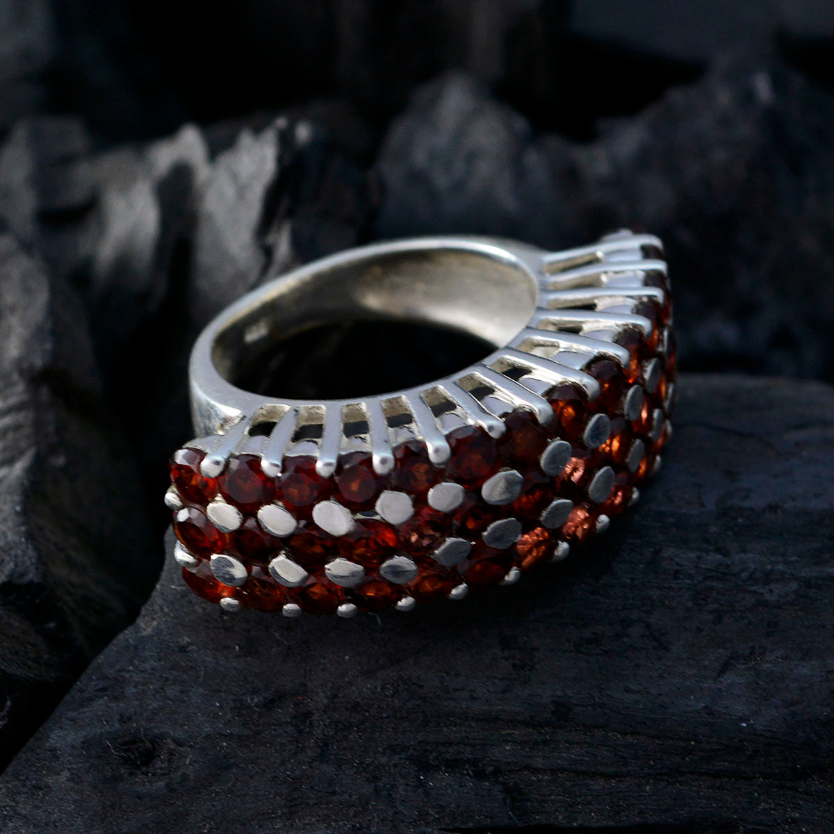 Julia Victorian red gemstone ring with multiple red stones set in silver band on dark background