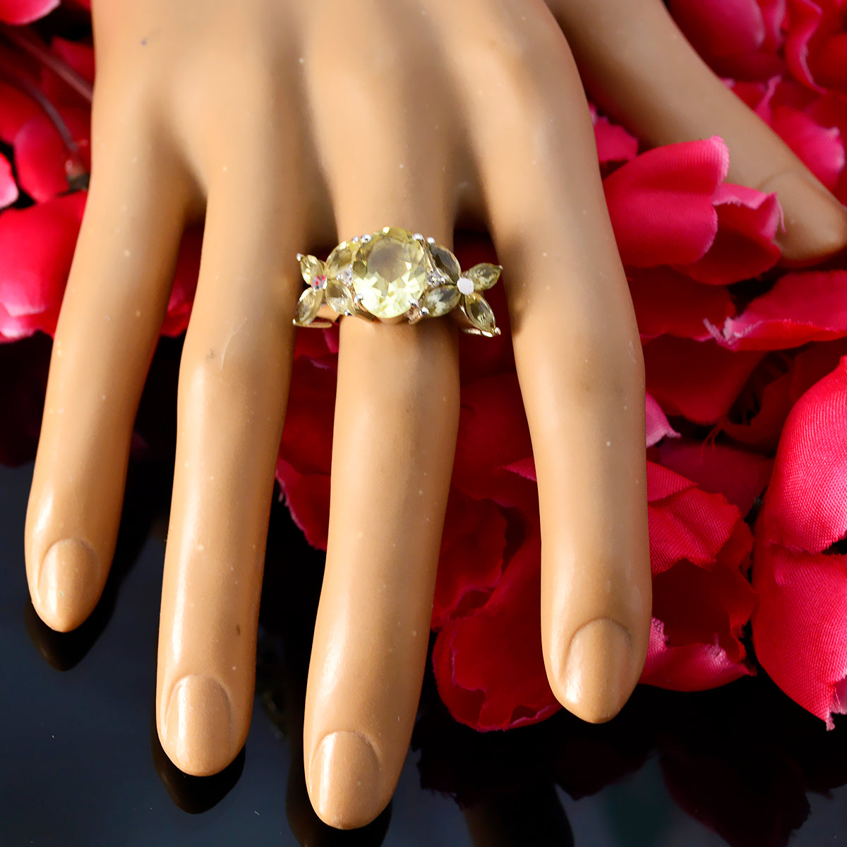 Sara yellow gemstone floral ring with round center stone and petal-shaped accents on display