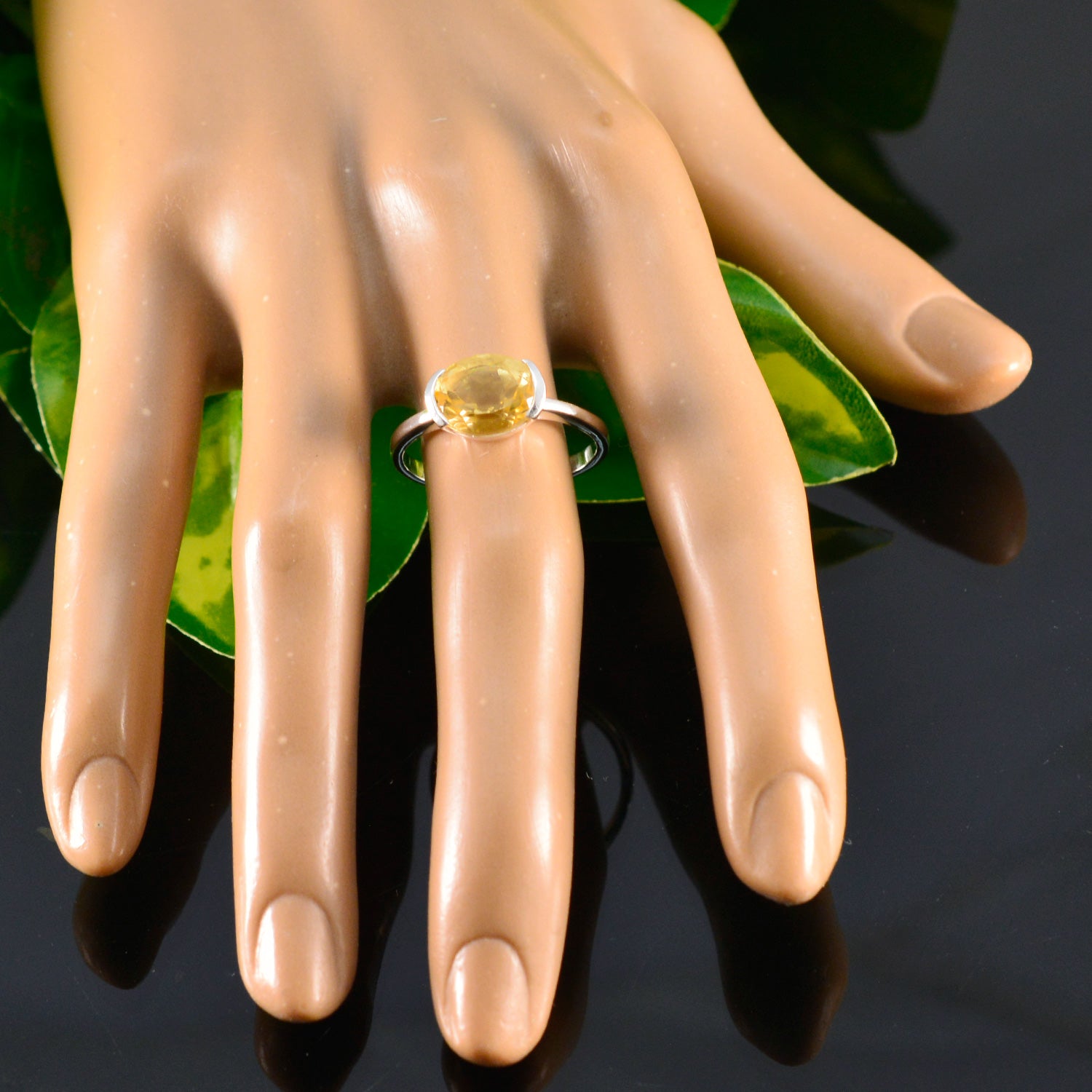 Stylish Zoey yellow solitaire ring set on a hand display with a vibrant yellow stone