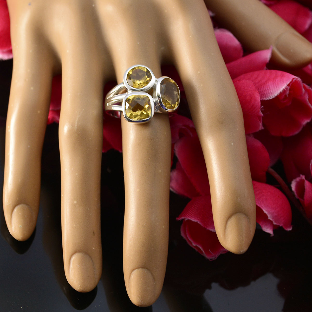 Savannah yellow trilogy gemstone ring with three yellow stones set in silver on display hand
