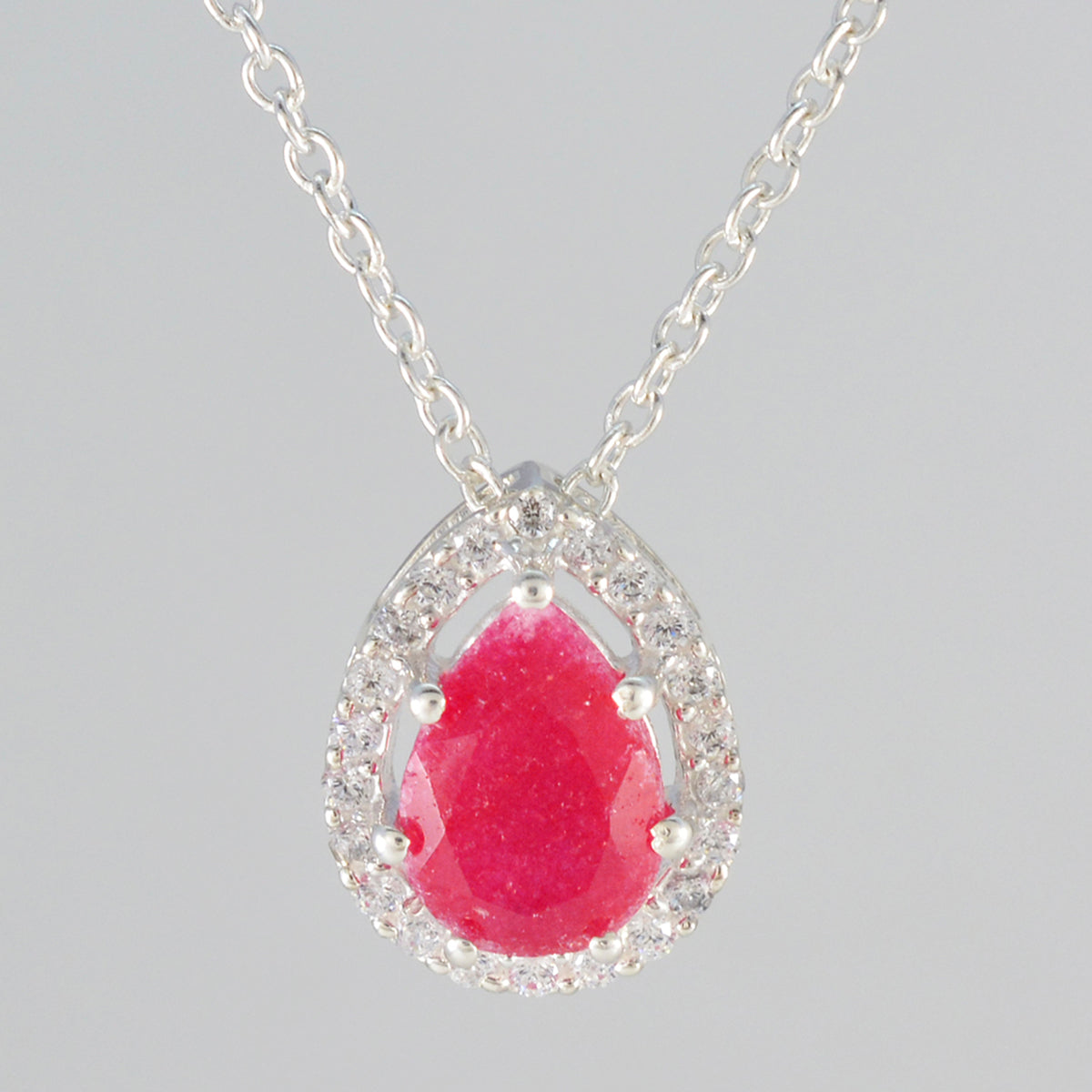 Zoey Red Dainty Pendant featuring a pear-shaped ruby surrounded by sparkling crystals